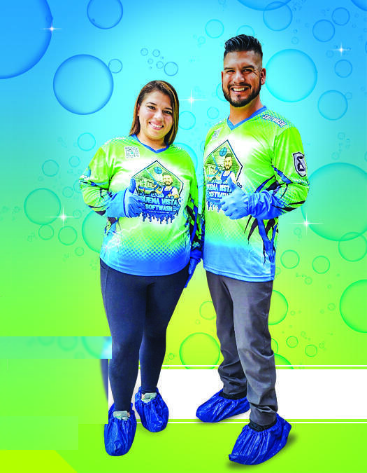 Bryan and Eric of Buena Vista Softwash, smiling in their blue and green team jerseys